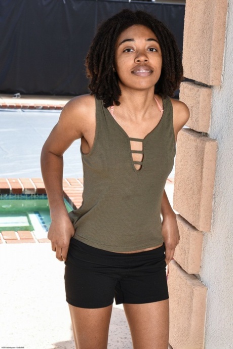 Black babe Olivia Green shows off her tiny tits & spreads her trimmed pussy